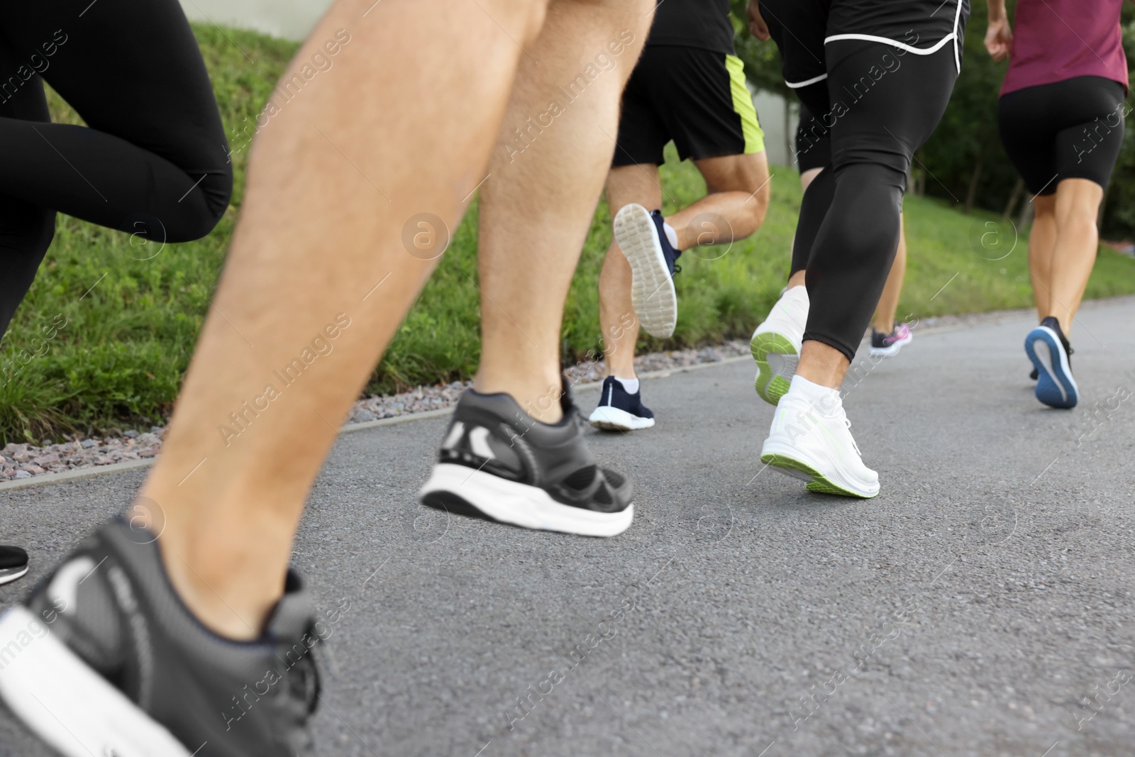 Photo of Group of people running outdoors, closeup view