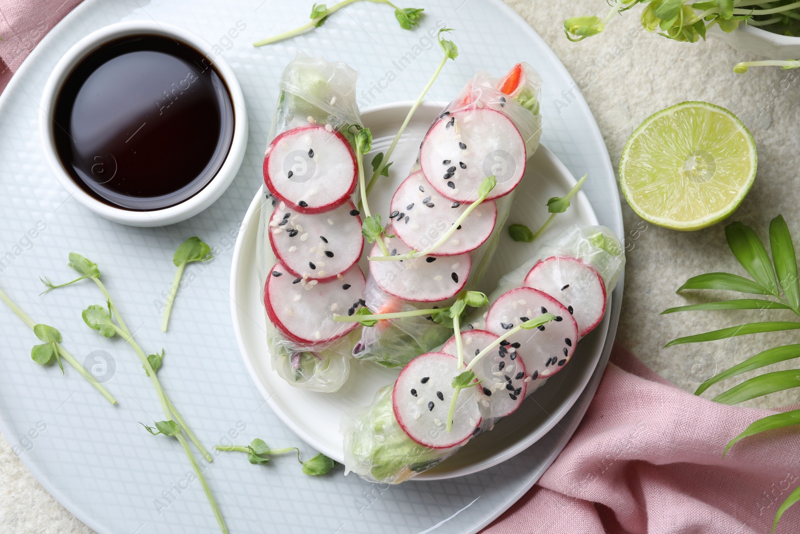 Photo of Delicious spring rolls served on light grey table, flat lay