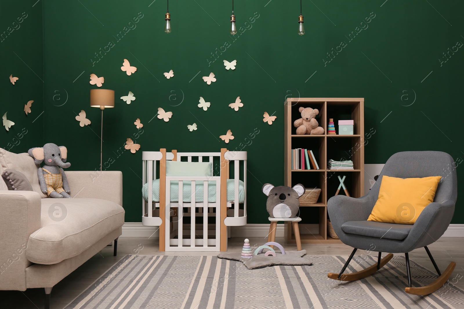 Photo of Beautiful baby room interior with stylish furniture and comfortable crib