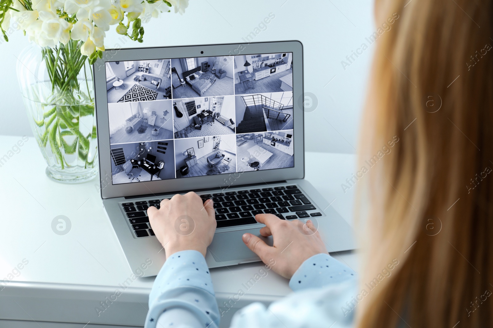 Image of Woman monitoring modern cctv cameras on laptop indoors, closeup. Home security system