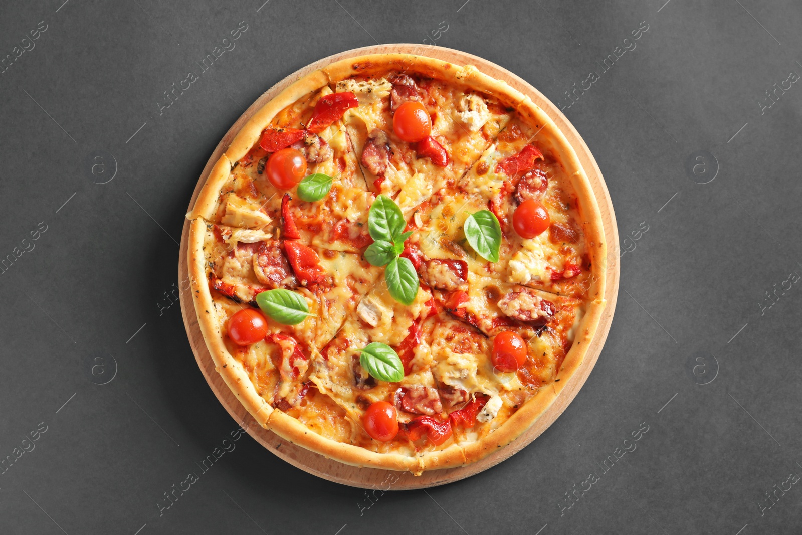 Photo of Delicious pizza with tomatoes and sausages on table, top view