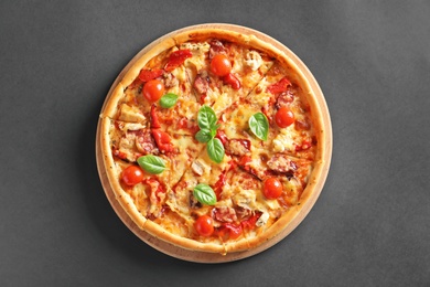 Photo of Delicious pizza with tomatoes and sausages on table, top view