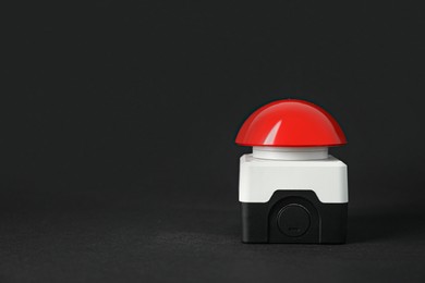 Red button of nuclear weapon on black background, space for text. War concept