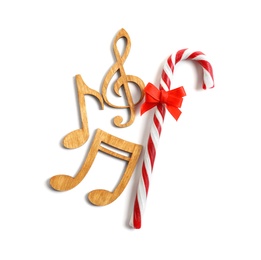 Wooden treble clef, notes and candy cane on white background. Christmas music concept