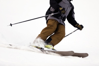 Photo of Skier on slope at resort, closeup. Winter vacation