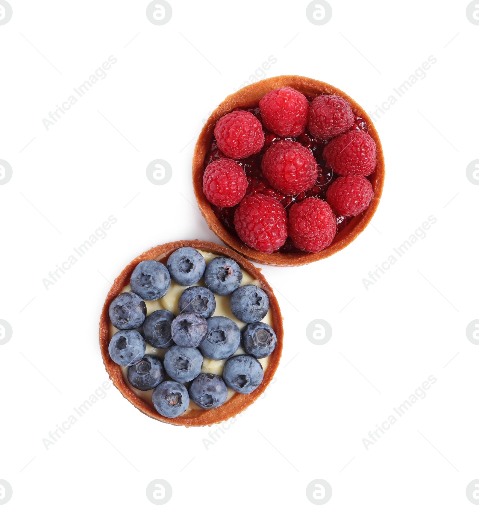 Photo of Tartlets with different fresh berries isolated on white, top view. Delicious dessert