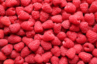 Photo of Fresh sweet ripe raspberries as background, closeup