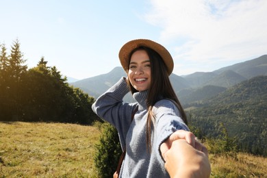 Photo of Young woman with her boyfriend in mountains on sunny day