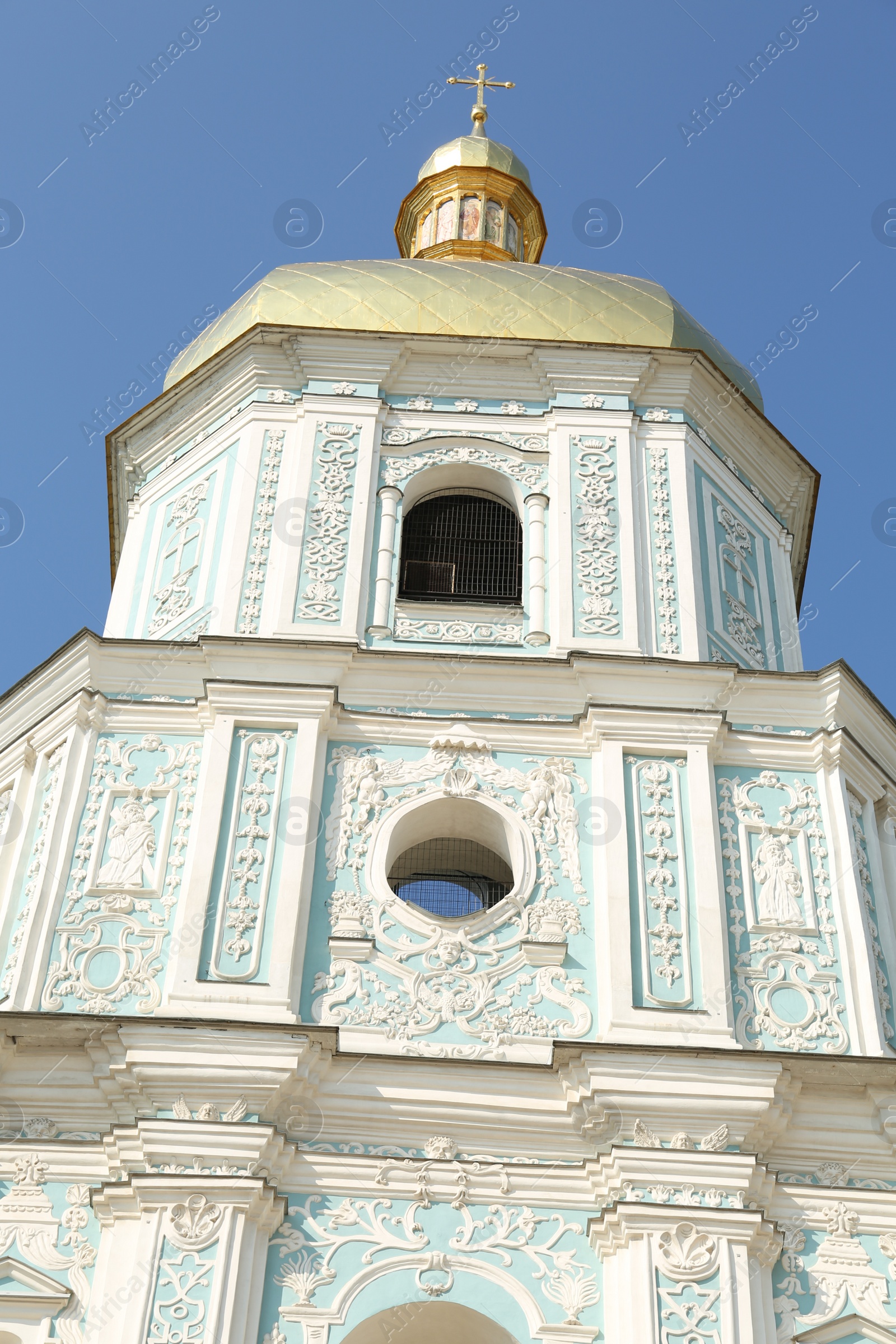 Photo of Beautiful church with golden dome against blue sky