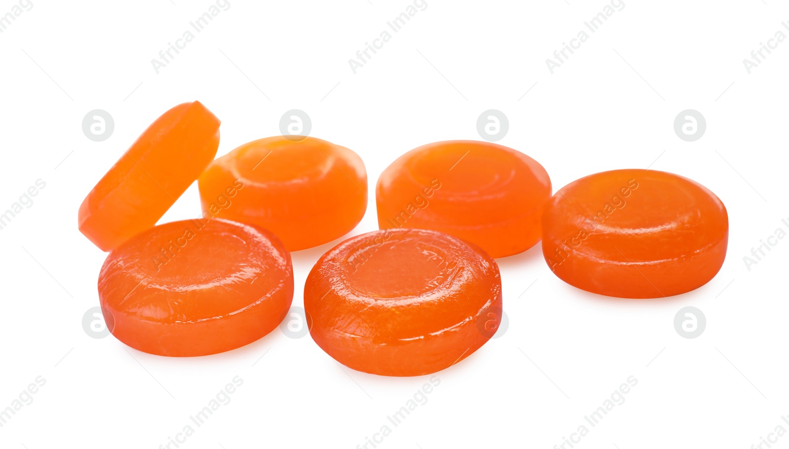 Photo of Many orange cough drops on white background