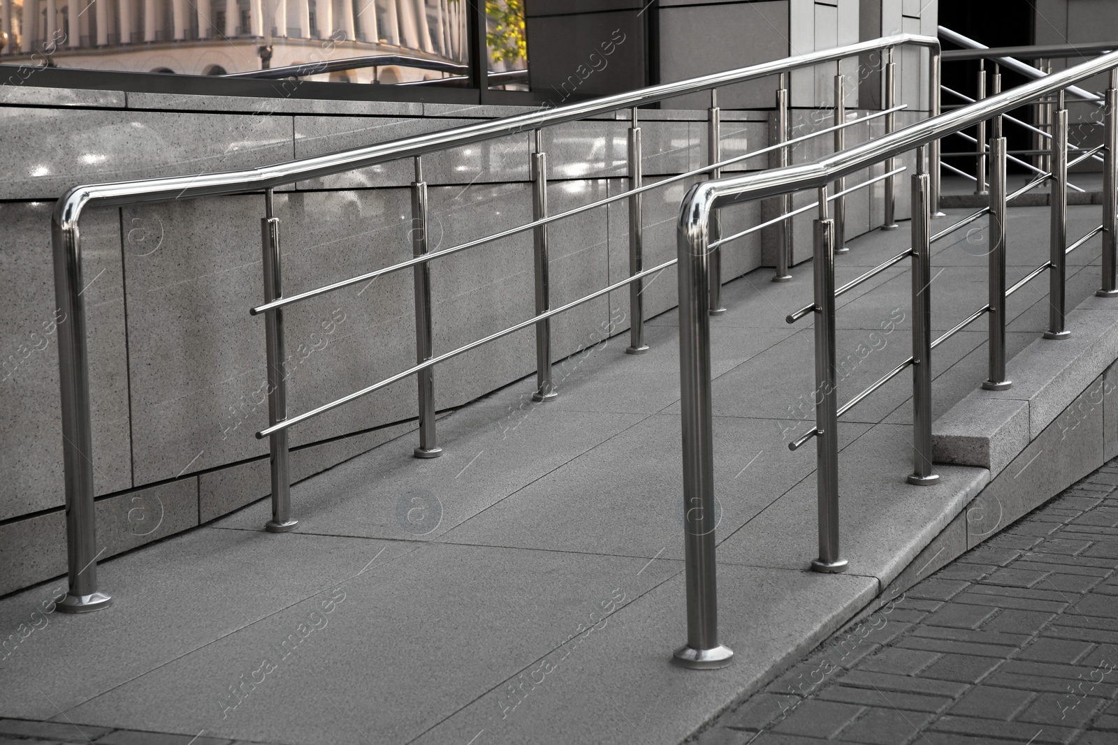 Photo of Ramp with metal handrails near building outdoors