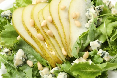 Photo of Delicious fresh salad with pear slices as background, closeup view