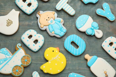 Photo of Set of baby shower cookies on light blue wooden table, flat lay