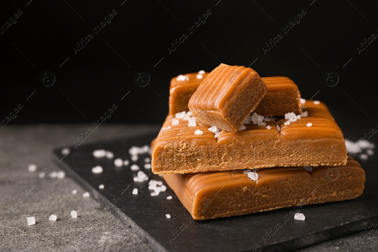 Photo of Salted caramel on light grey table, closeup view