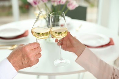 Photo of People with glasses of wine on blurred background, closeup