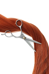 Photo of Red hair and scissors on white background, top view. Hairdresser service