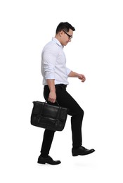 Businessman with briefcase walking on white background