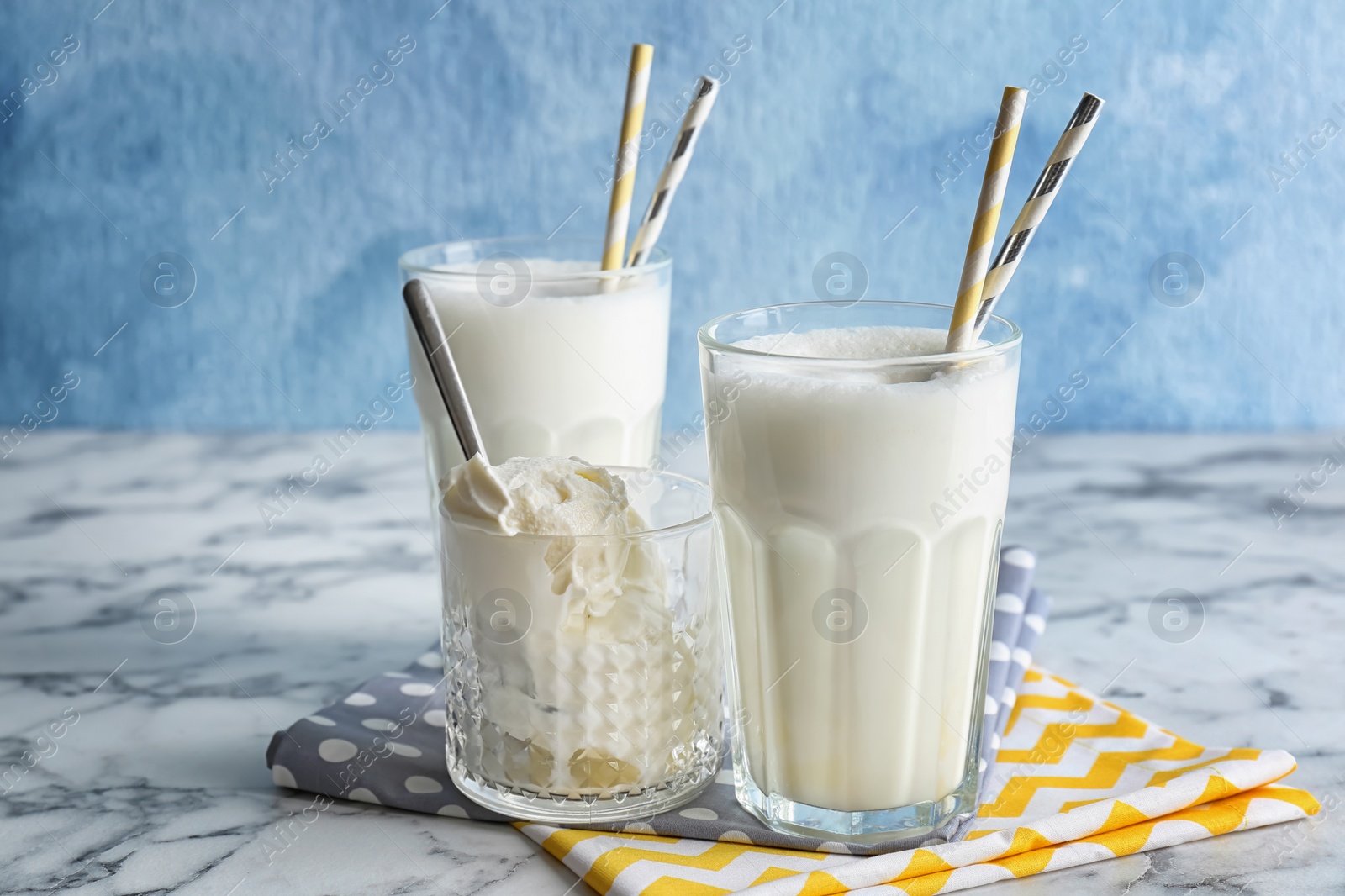 Photo of Glasses with milk shake and tasty vanilla ice cream on table