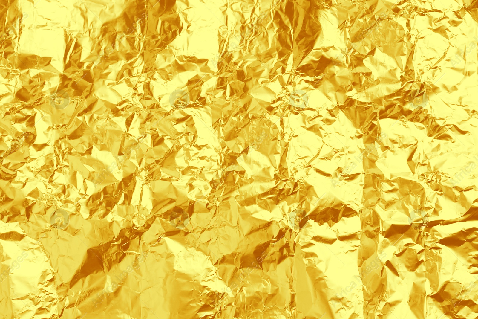 Image of Crumpled golden foil as background, closeup view