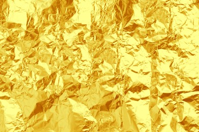 Crumpled golden foil as background, closeup view