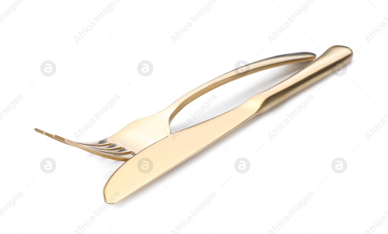 Photo of Shiny golden fork and knife isolated on white. Luxury cutlery