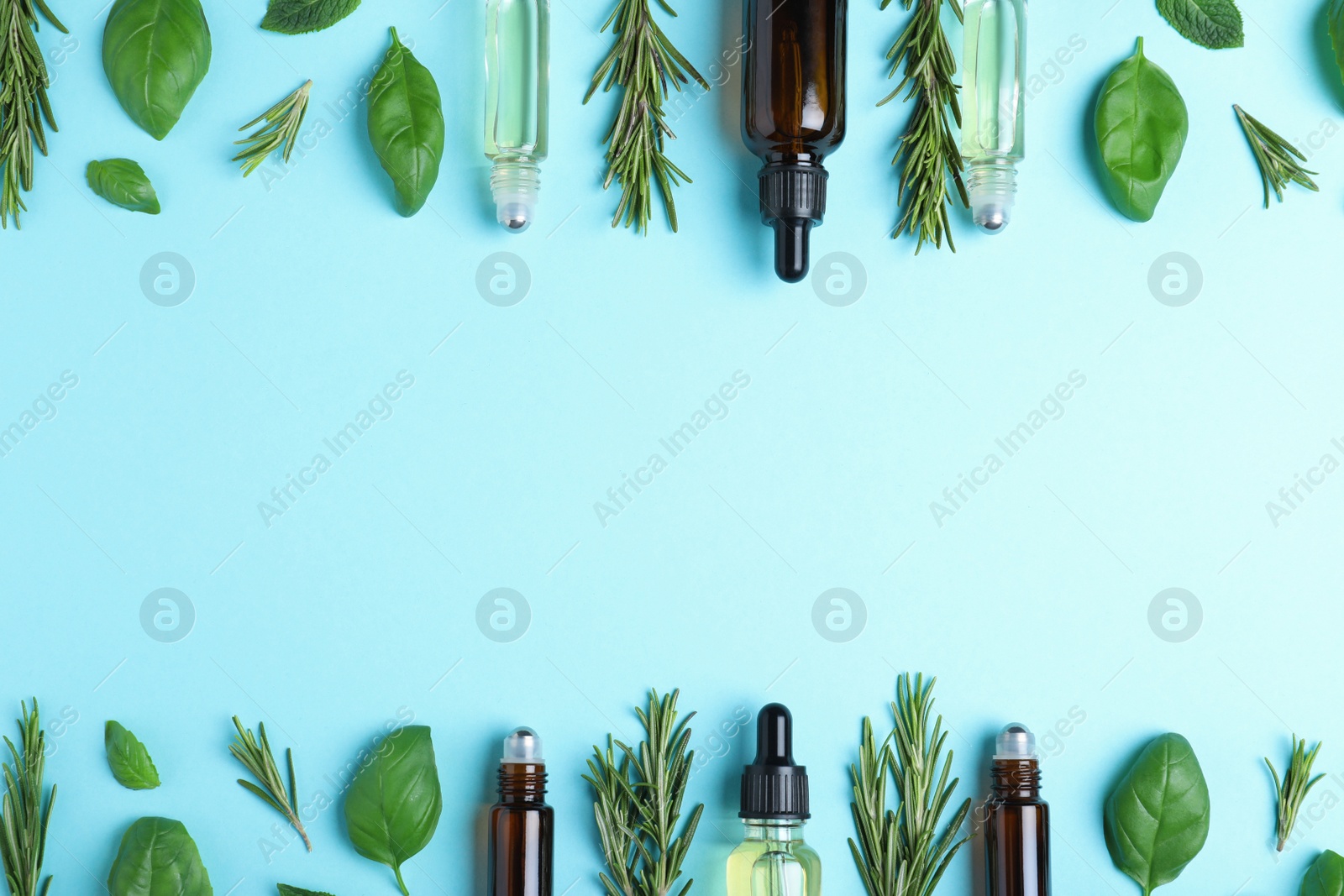 Photo of Flat lay composition with herbal essential oils and space for text on light blue background