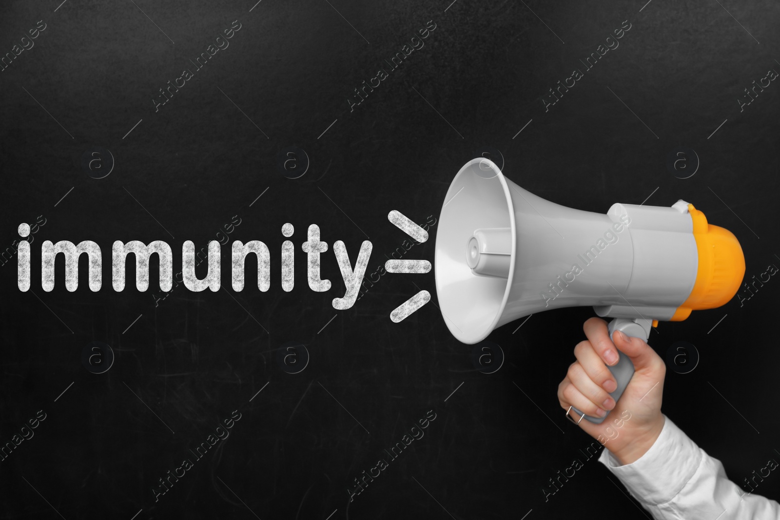 Image of Man holding megaphone near chalkboard with word Immunity, closeup