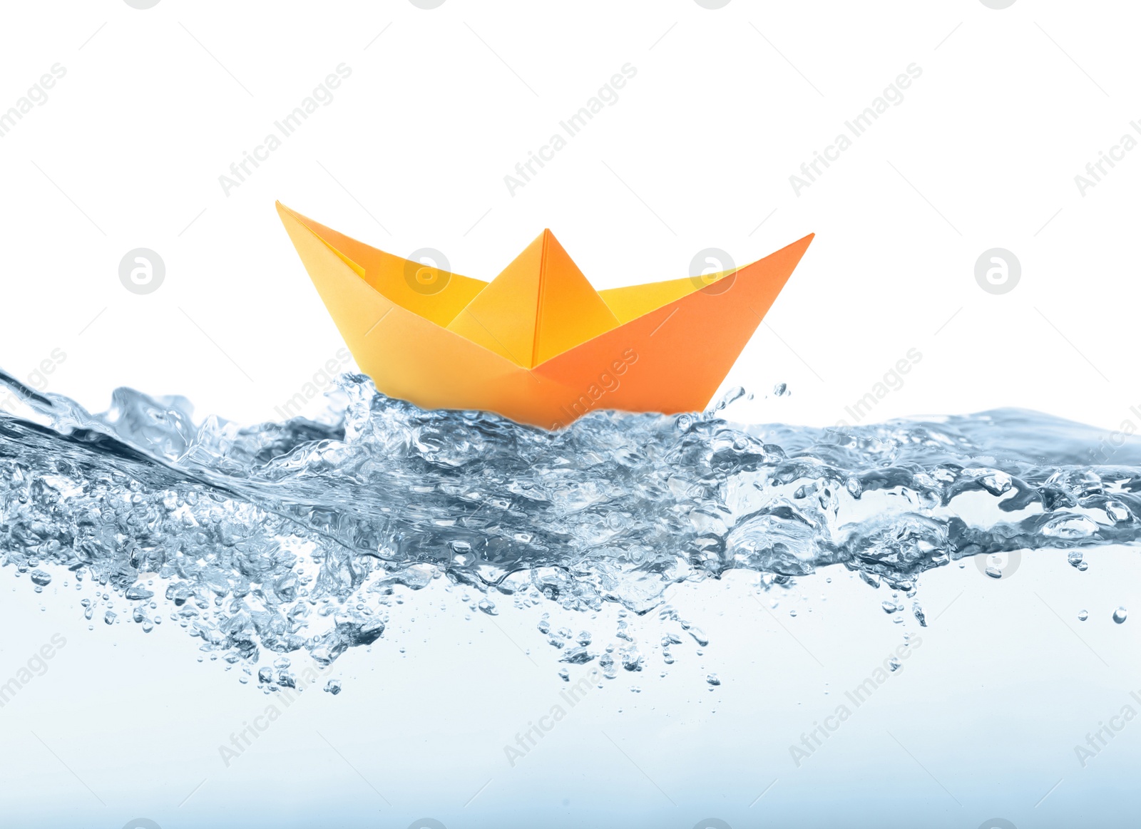 Image of Handmade orange paper boat floating on clear water against white background 