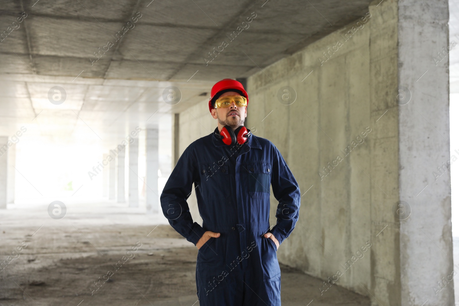 Photo of Professional builder in safety equipment at construction site