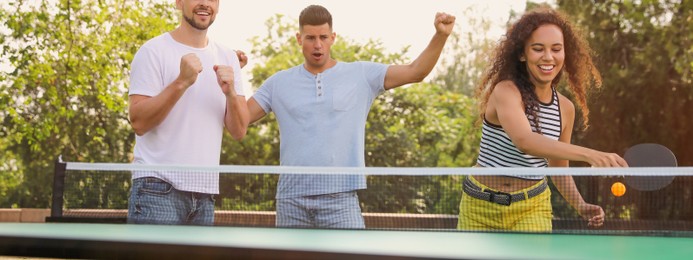 Image of Friends playing ping pong outdoors on summer day. Banner design