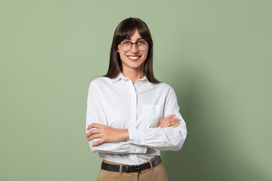 Portrait of happy secretary on light olive background