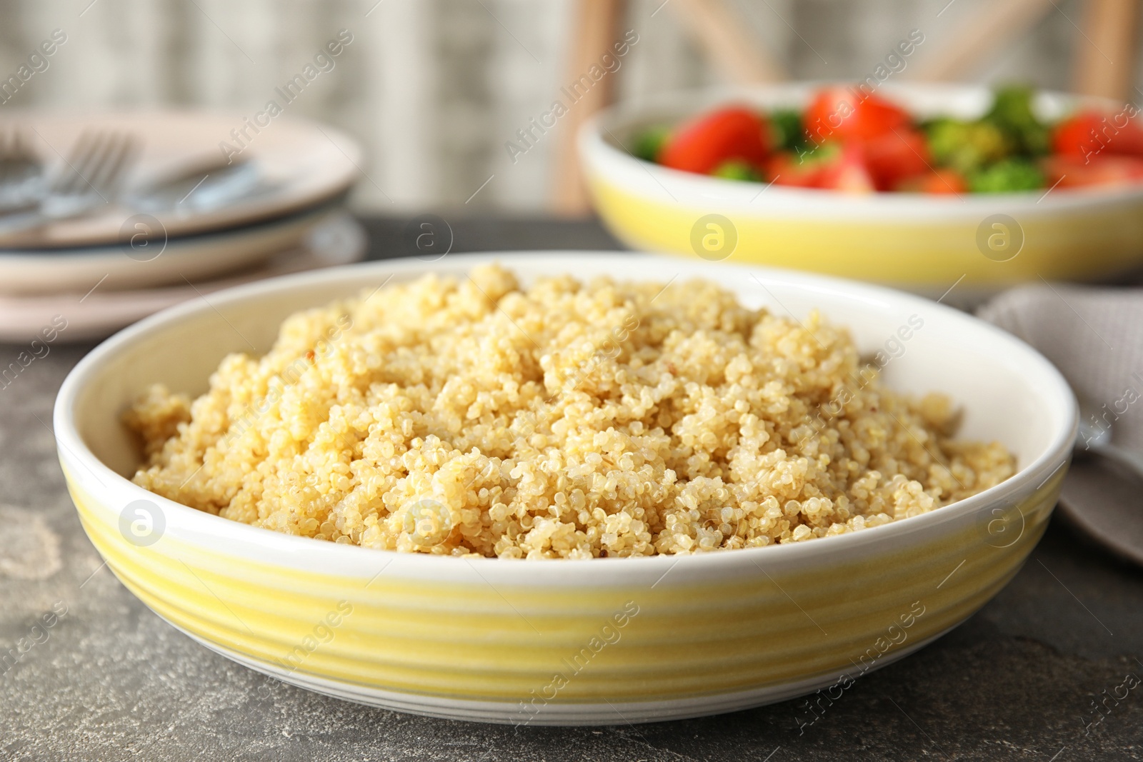 Photo of Delicious cooked quinoa in plate on table