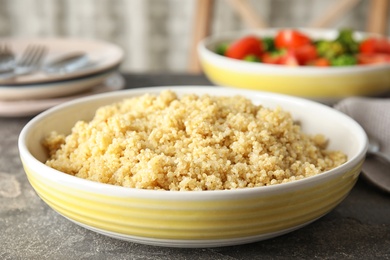 Photo of Delicious cooked quinoa in plate on table