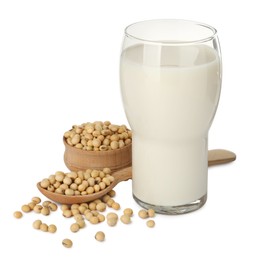 Photo of Glass of fresh soy milk and beans on white background