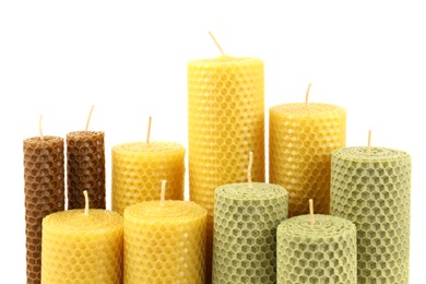 Stylish elegant beeswax candles isolated on white
