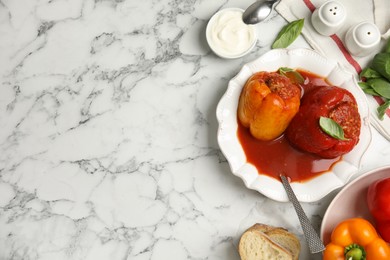 Photo of Delicious stuffed peppers served on white marble table, flat lay. Space for text
