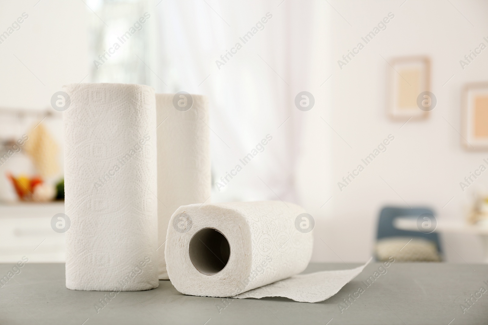 Photo of Rolls of paper towels on table in kitchen