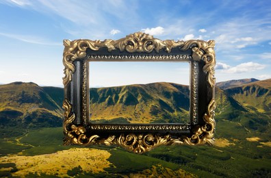 Image of Vintage frame and beautiful mountains under blue sky with clouds