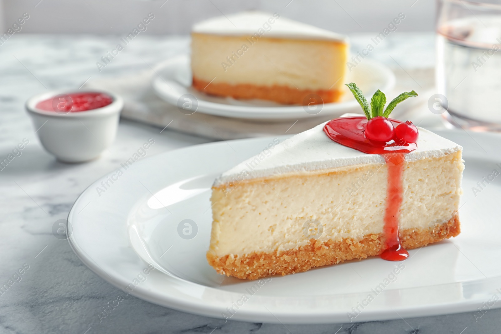 Photo of Delicious cheesecake served with sweet jam on plate