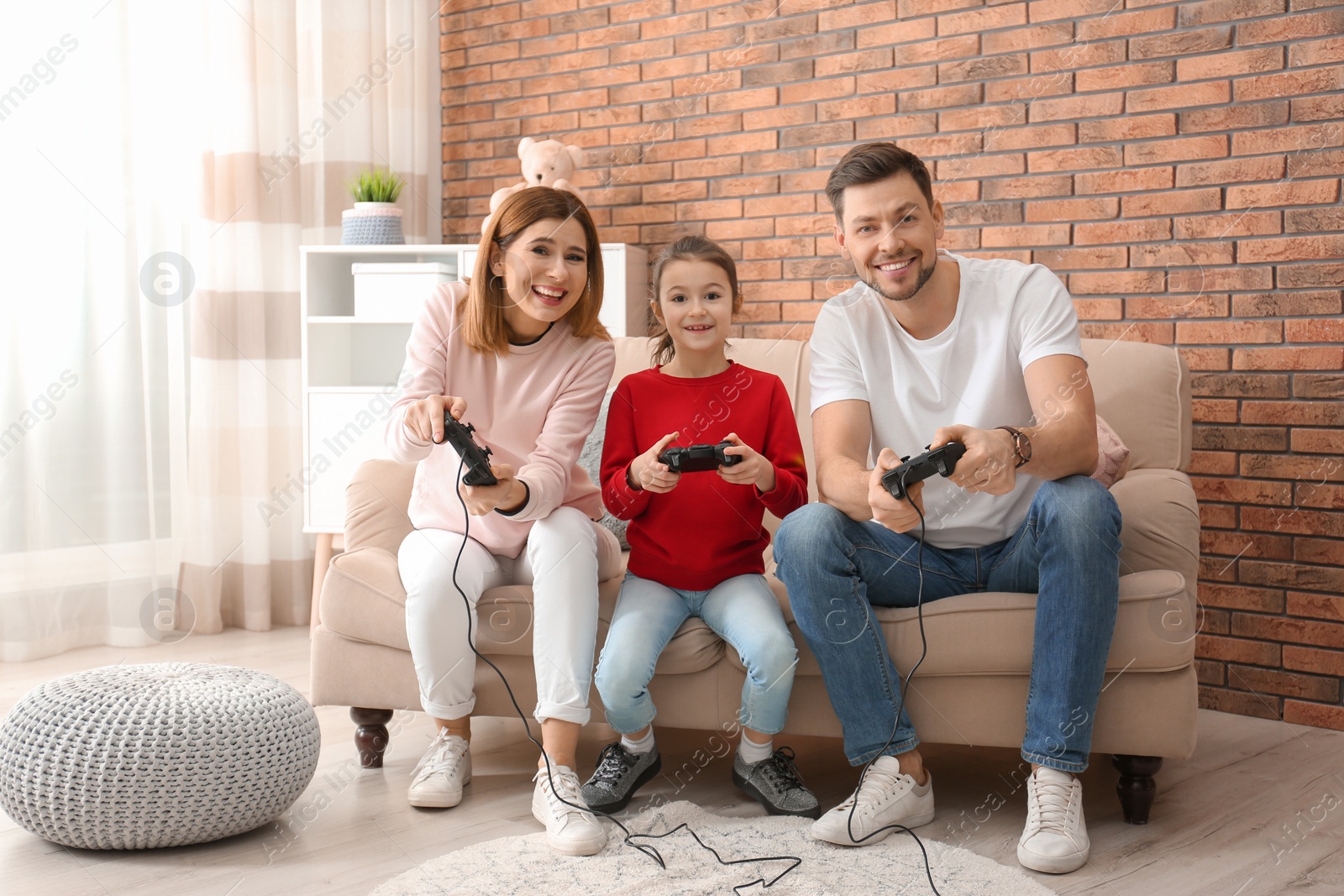 Photo of Happy family playing video games in living room