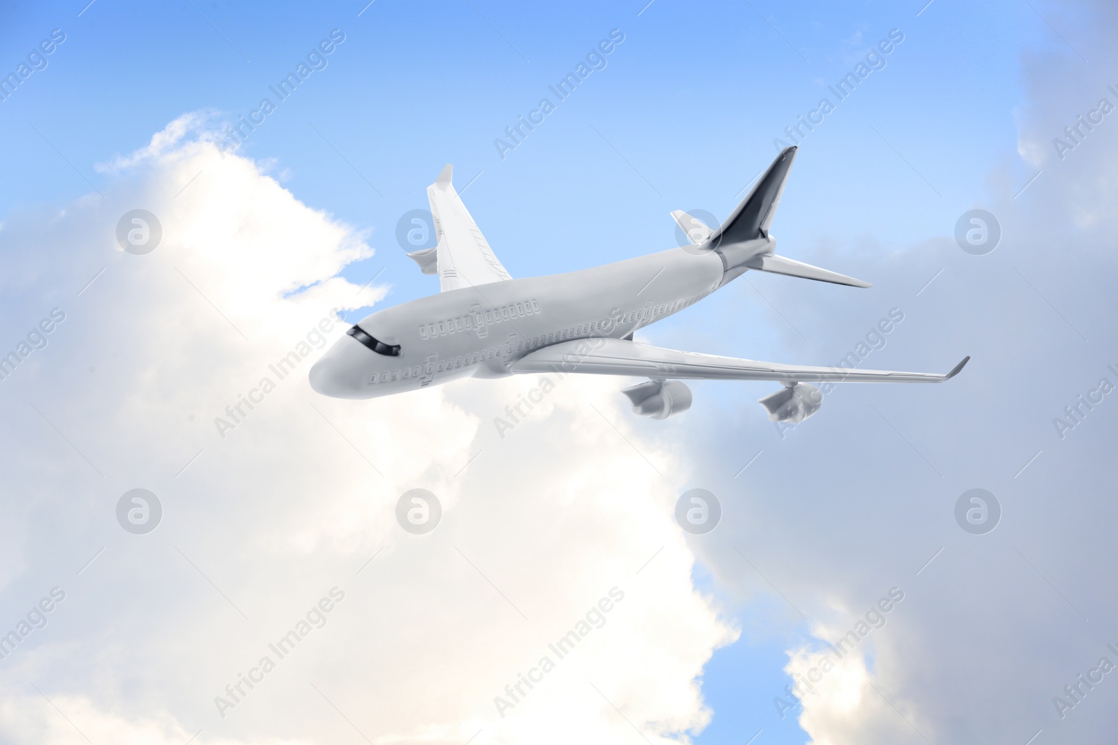 Image of Airplane flying in blue sky with clouds. Air transportation