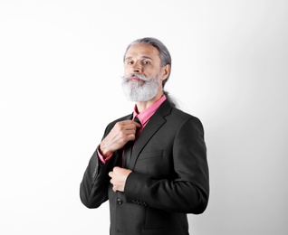 Photo of Handsome bearded mature man in suit on white background