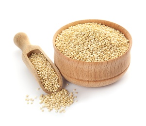 Bowl and scoop with raw quinoa on white background