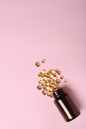 Photo of Bottle with cod liver oil capsules on color background, flat lay. Space for text