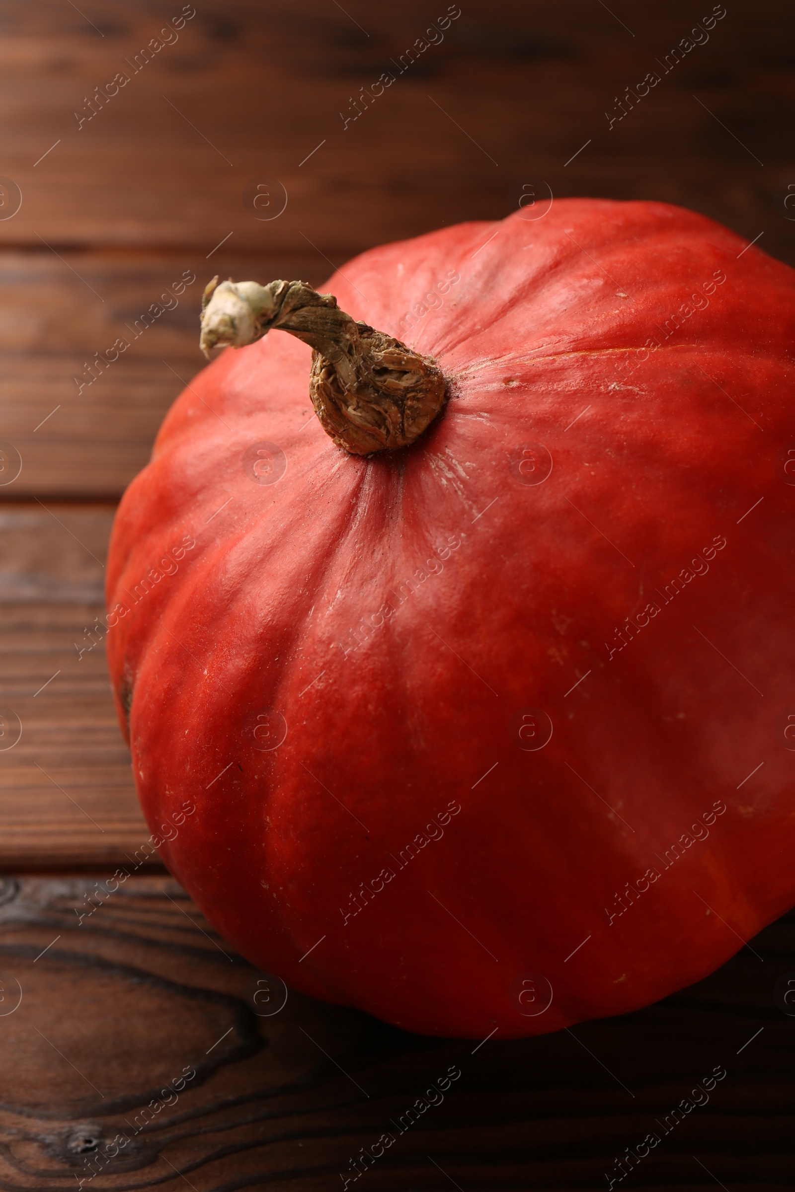 Photo of Fresh orange pumpkin on wooden table, closeup