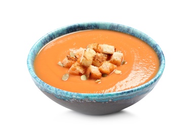 Photo of Tasty creamy pumpkin soup with croutons and seeds in bowl on white background