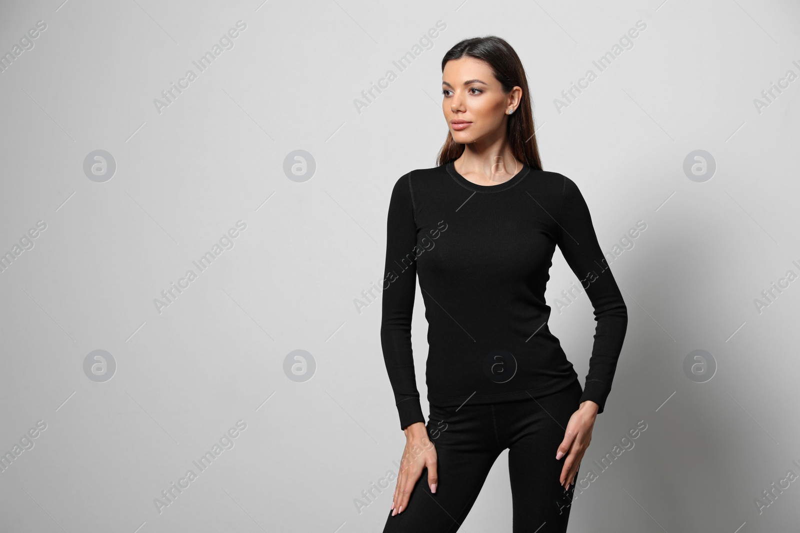 Photo of Woman wearing thermal underwear on light grey background. Space for text