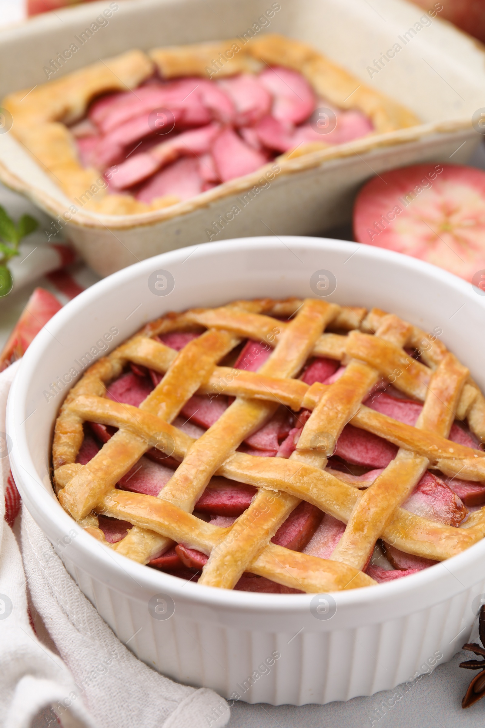 Photo of Baking dish with delicious apple pie on table, closeup