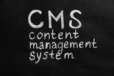 Photo of Abbreviation CMS (Content Management System) on black background