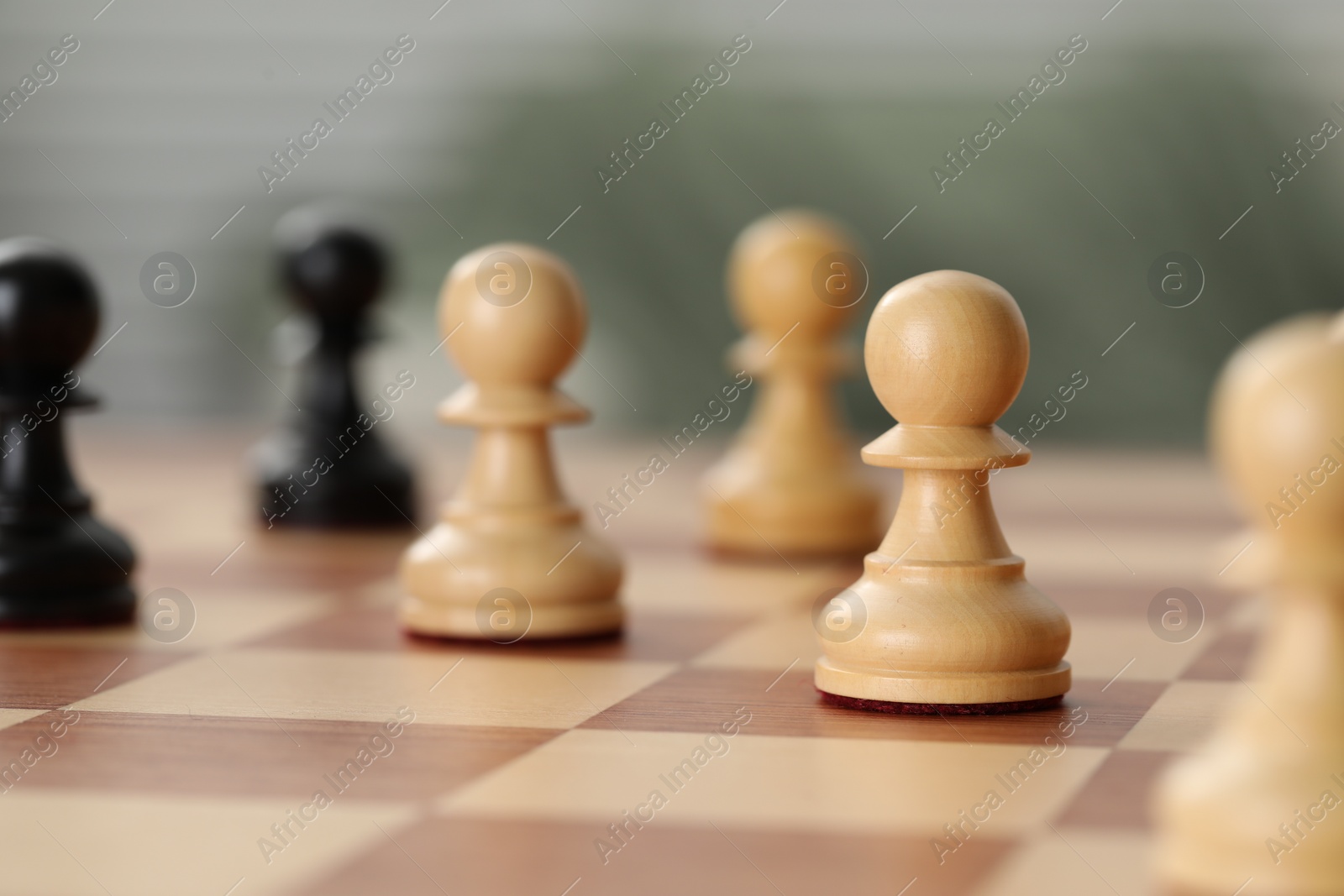 Photo of Wooden pawns on chess board, closeup. Space for text